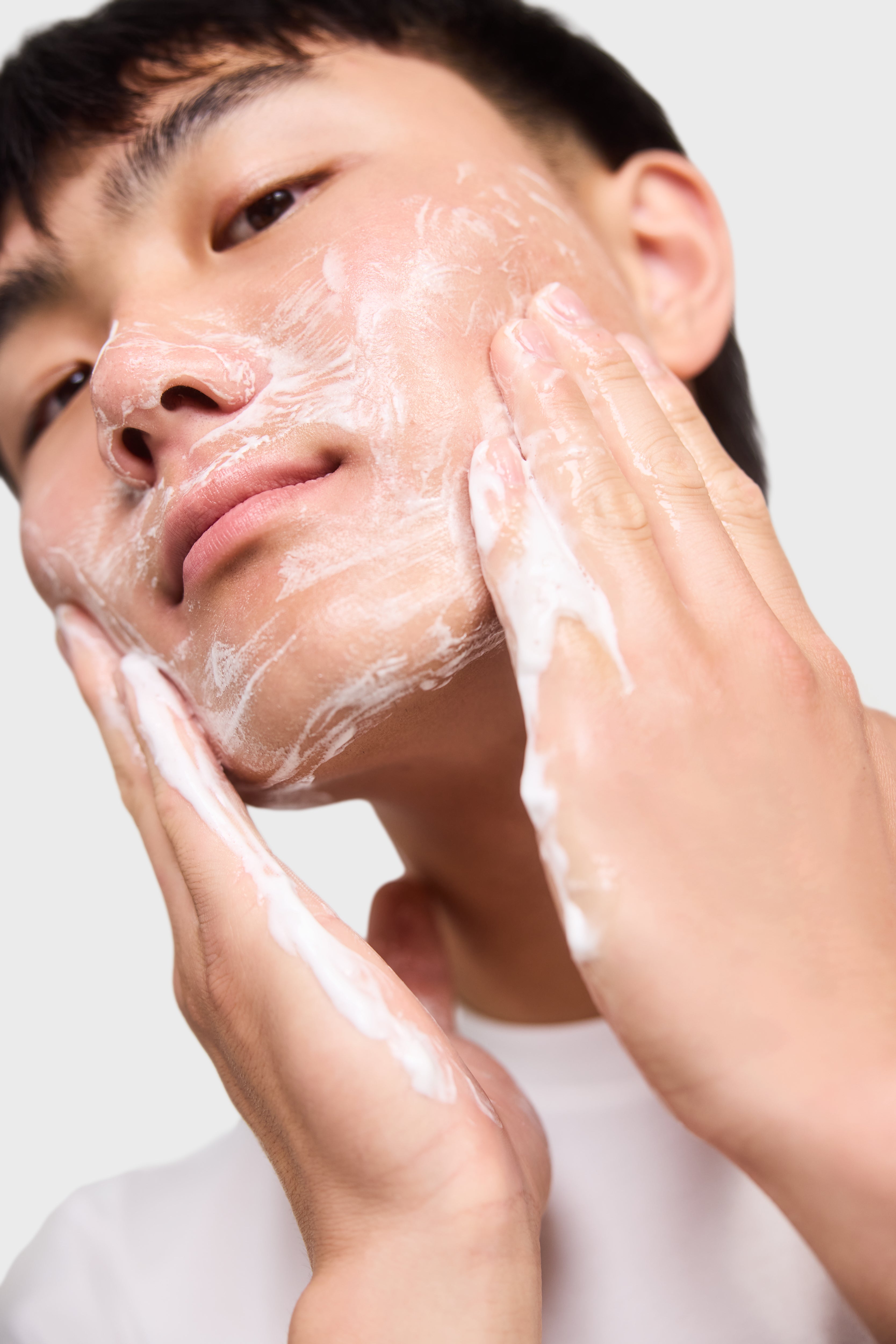 Image of young teen boy washing his face